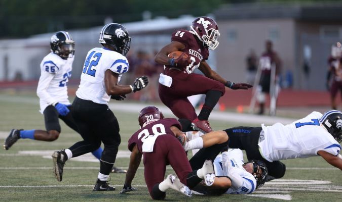 Lazarus Fisher leaps over defenders